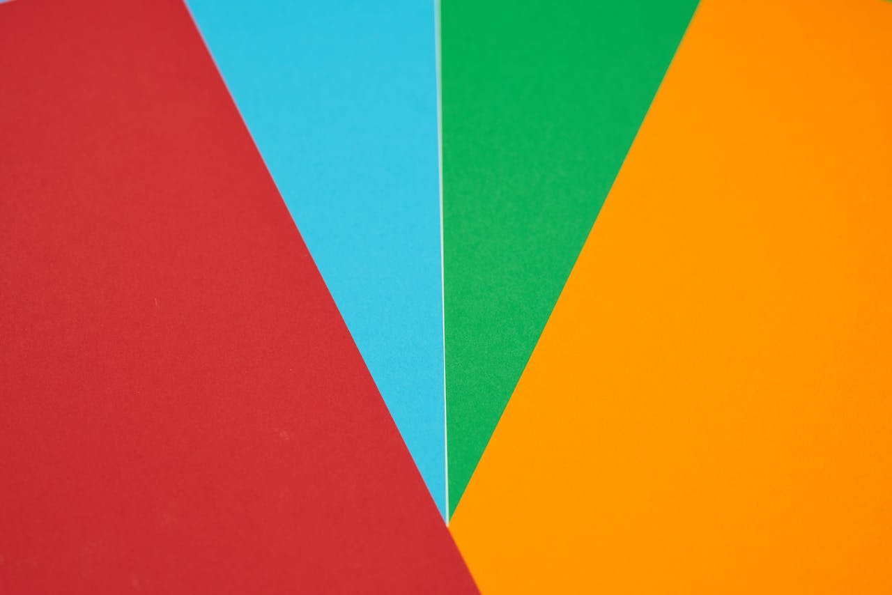 Colorful abstract design featuring red, blue, green, and orange geometric shapes.